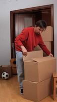 Man moving boxes in a room video