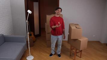 A man standing in a room with boxes and a lamp video