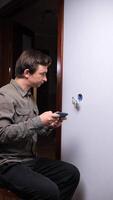 A man is using a cell phone to check the time video