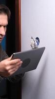 A man holding a tablet computer video