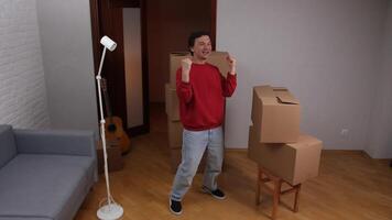 A man is standing in a room with boxes video