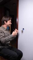 A man is fixing a light switch in a room video