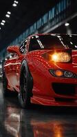 Red sports car showcased in a modern auto exhibition with striking lighting and polished surfaces photo