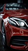 Sleek red sports car with raindrops glistening on the surface in an indoor showroom setting photo