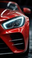 Bright red sports car showcasing sleek design with glowing headlights in a dimly lit garage setting photo