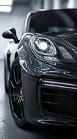 Sleek black sports car showcases modern design in dimly lit garage environment photo