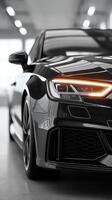 High-performance black sports car capturing light in modern indoor showroom environment photo