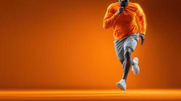 Athlete running in bright orange attire on a vibrant background during a training session photo