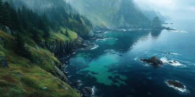 Misty coastal view showcasing jagged cliffs and tranquil waters at dawn on a serene morning photo