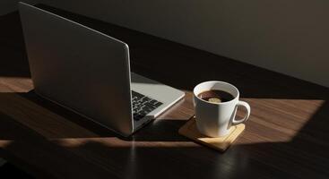 Laptop and Coffee Cup on Wooden Desk with Sunlight photo