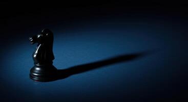 Black Chess Knight Piece with Long Shadow photo