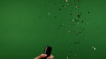 Man explodes a firecracker with shiny confetti footageschromakey, green screen video