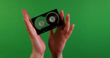 A VHS Tape is seen in motion against a vibrant green background, creating a striking visual effect video
