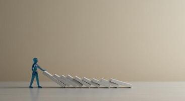 Abstract figure pushing falling dominoes photo