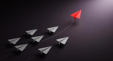 Red paper airplane leading white paper planes photo
