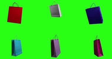 Bright shopping bags arranged against a green background create a striking display video