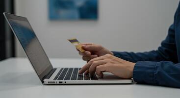 Businessman Using Laptop and Credit Card for Online Payment photo