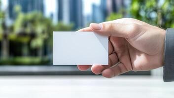 Hand Holding Blank Business Card in City photo