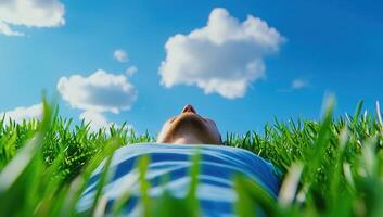 Person Lying in Grass Looking at Sky photo