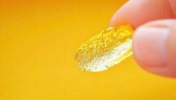 Close Up of Hand Holding Shiny Gold Foil photo