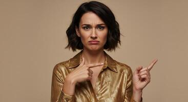Confused woman pointing at herself and to the side showing uncertainty photo