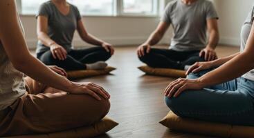 Group meditation session with people sitting in a circle on floor cushions photo