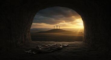 Empty tomb with burial cloth looking at three crosses on a hill at sunset photo