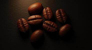 Roasted coffee beans scattered on a dark textured surface close up overhead view photo