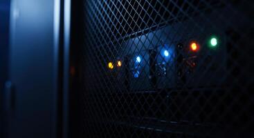 Close up of server rack mesh door with blinking status lights photo