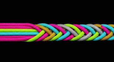 Colorful ropes braiding together symbolizing unity and connection photo