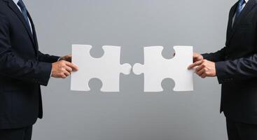 Two Businessmen Connecting White Puzzle Pieces Teamwork Partnership Solution Concept photo