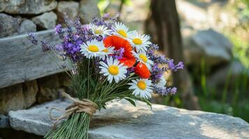 A Bouquet of Daisies, Lavender, and Poppies Resting on a Stone photo