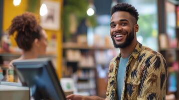 A smiling man in a floral shirt interacting with a cashier photo