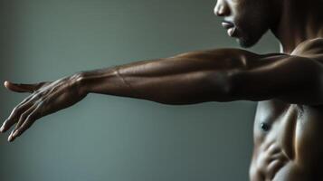 Muscular Man's Arm Extended, Reaching Out, with a Gray Background photo