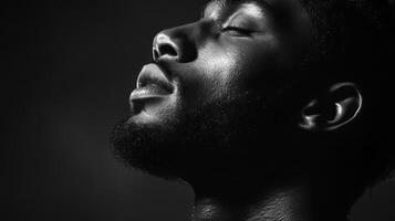 Close-up Black and White Portrait of a Man with his Eyes Closed photo