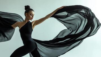 Woman in Black Dress and Flowing Fabric photo