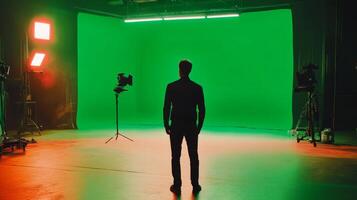 A Man Standing In Front of a Green Screen in a Studio Setting photo