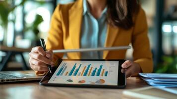 Businesswoman analyzing financial data on a tablet photo