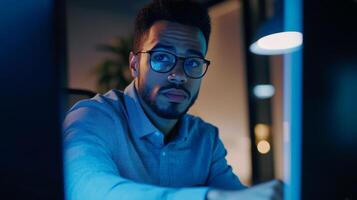 Focused Man Working Late at Night in Office photo