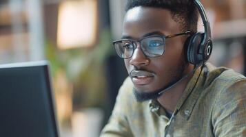 Black Man in Glasses with Headset Using Computer photo