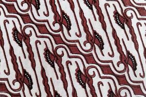 A close up of a red and white patterned fabric photo