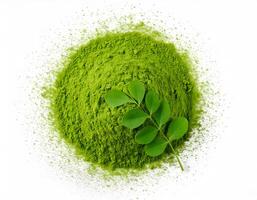 Top view of moringa powder with moringa leaf on white background photo