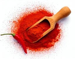 Top view of Chili powder wood spoon with fresh red chili on white background photo