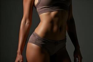 Athletic Woman Posing in Dim Light with Toned Body and Confidence photo