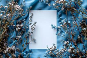 A white square frame surrounded by blue flowers photo