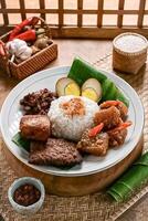 Nasi Gudeg Jogja is a traditional Yogyakarta dish of sweet jackfruit stew served with rice, chicken, boiled eggs, sambal, and spicy crispy beef skin known as krecek photo