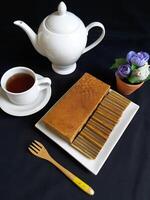 Indonesian Layer Cake or Kue Lapis Legit, is a very rich, moist, spice-flavoured butter cake which is baked layer by layer, flavoured with ground mixed spices such as cinnamon and nutmeg. photo