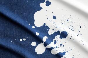 Bleached denim featuring unique splattered patterns on a white background ideal for fashion and design projects photo