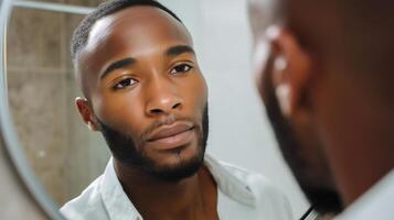 Man looking in mirror with satisfaction in a neutral backdrop, reflecting confidence and self-acceptance photo