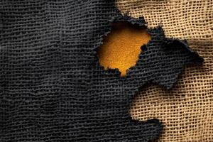 Burnt burlap texture featuring smoldered holes and frayed edges on a surface photo